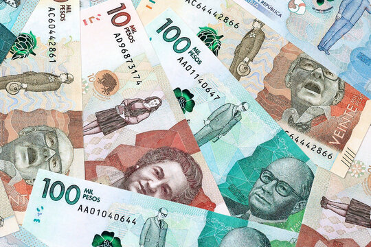 Colombian peso money bills in pile on table. Colombia COP currency cash close up