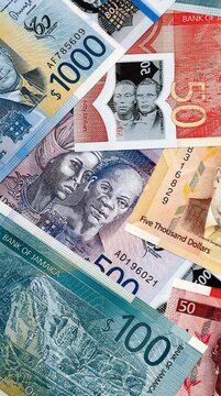 Jamaican dollar money bills in pile on table. Jamaica JMD currency cash close up