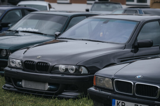 Madona, Latvia - July 11, 2026: Black BMW E39 sedan parked among other vehicles in a car gathering, showcasing distinct design features and front grille