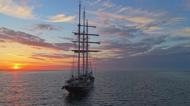Tall ship gulden leeuw sailing at sunset in terschelling