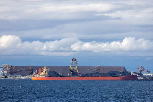Bulk Carrier Cargo Ship Docked At Industrial Port Under Dramatic Clouds In Tsawwassen British Columbia