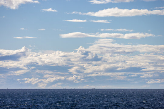 Calm Ocean Horizon With Layered Clouds Over Tsawwassen, British Columbia, Canada