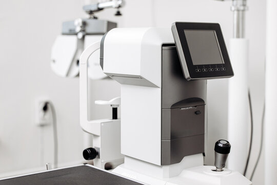 Modern eye examination equipment on a medical desk in an optometry office. Concept ophthalmic diagnostics, vision care, healthcare technology, eye examination, prevention.
