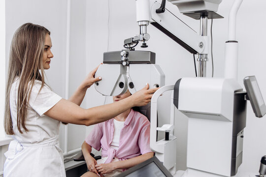Ophthalmologist preparing vision testing equipment before an eye examination. Concept ophthalmology, visual acuity assessment, eye care, clinical diagnostics, medical technology.