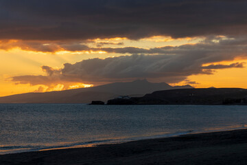 Obraz premium Fuerteventura island Canary islands Spain. Sunset view Tarajalejo beach, located in the municipality of Tuineje in southern Fuerteventura, is a semi-urban beach with black volcanic sand and pebbles, 