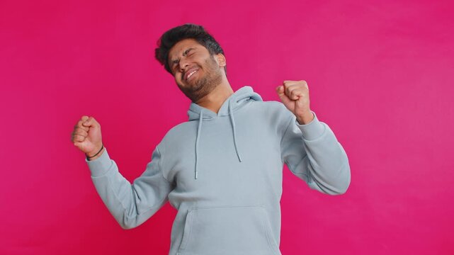 Tired exhausted Indian young man yawning, sleepy inattentive feeling somnolent lazy bored gaping suffering from lack of sleep, falling asleep. Arabian Hindu guy isolated on pink studio background