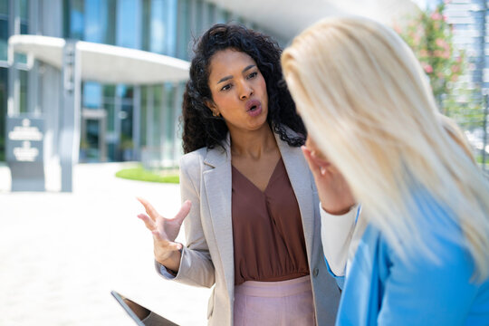 Businesswomen having argument outside office building