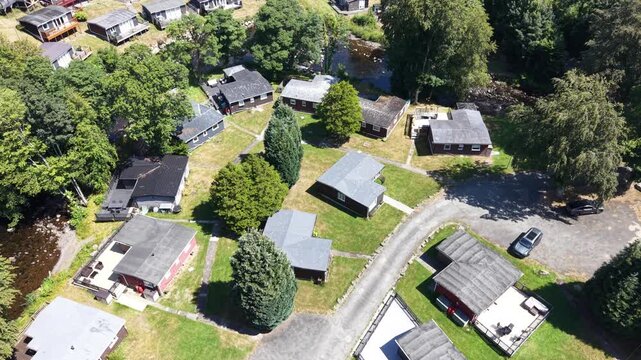 Aerial drone 4K clip showing caravans placed across rolling countryside vegetation under warm daylight Wales