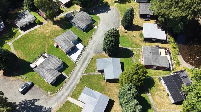 Aerial drone 4K footage showing caravans arranged across bright countryside greenery with warm natural daylight Wales