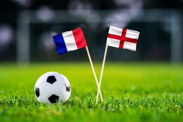 Obraz premium France vs England, Third place match, national flags before international football match, football on green grass with stadium in the background, Miami Gardens, July 18, 2026.