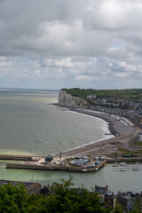 Fototapeta premium Mers-les-Bains, seaside town with 19th-century sea-bathing villas with colorful wooden balconies and white chalk cliffs, tourists destination in France