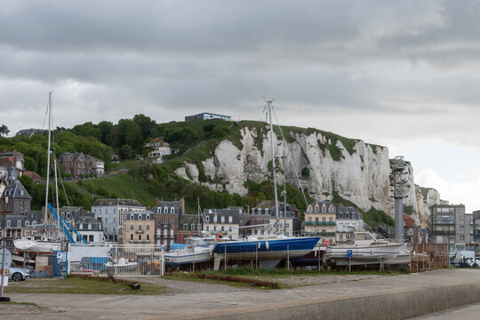 Views of Le Treport, seaside resort in Normandy, France, with white cliffs along  English Channel, fishing industry and old buildings, travel destination in France