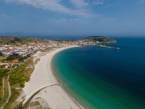 Coastal village beach and bay with turquoise water