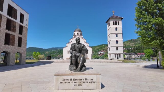 Andricgrad, Visegrad, Bosnia and Herzegovina - May 30, 2026: Central square with the Church of Saint Lazar and statue of Ivo Andric