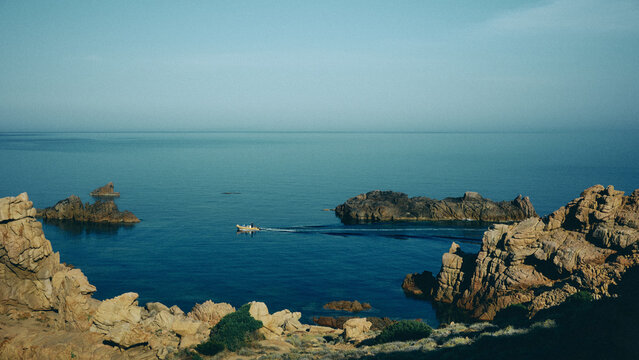 view of a boat in the sea from the mountains of Sardinia