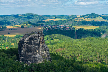 Obraz premium Falkenstein sandstone cliff overlooking fields and forest in Saxon Switzerland 