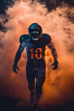 American football player emerging through dramatic orange smoke before a game
