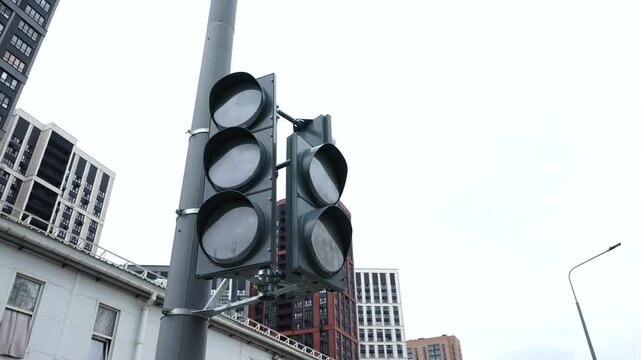 Traffic light at an urban intersection with modern buildings representing city transportation, mobility and infrastructure development
