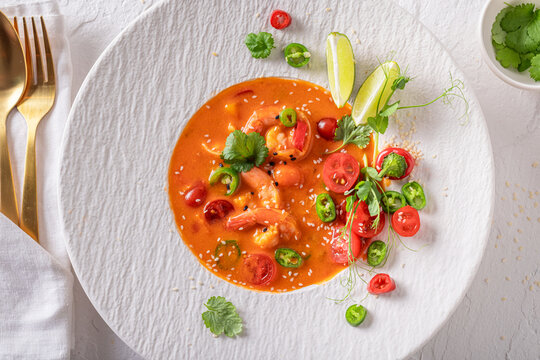 Professional and hot Thai soup decorated with sesame and coriander.