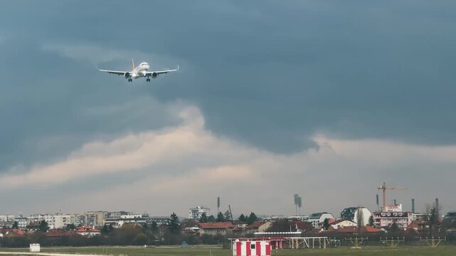 Passenger Plane Landing at Sofia Airport Under Overcast Sky