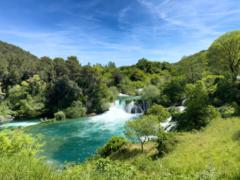 waterfalls and cascade mountain river running through the forest during late spring showing complete bottom large pool