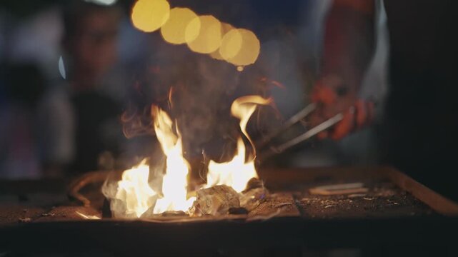 Artisan Blacksmith Heating Metal in Fiery Forge Flames