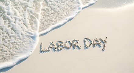 Labor Day text written in sand with ocean foam