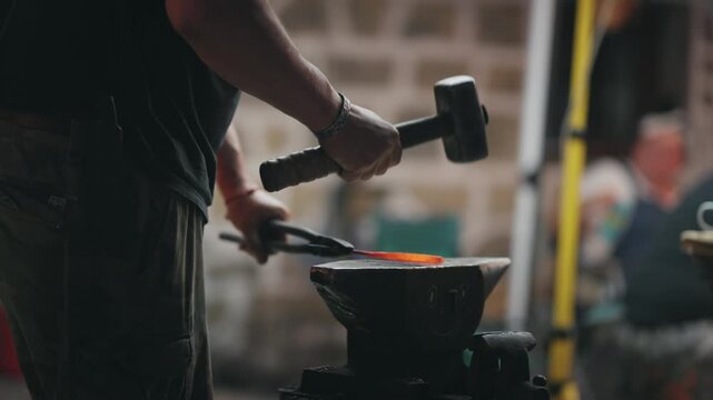 Blacksmith Forging Handmade Knife with Hammer in Workshop