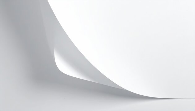 Close-up of plain white paper with a corner delicately curled upwards. Soft shadows provide depth