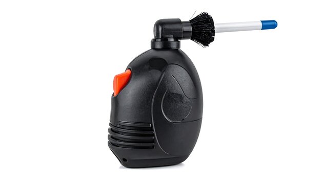 A black, egg-shaped device with a protruding brush and orange button