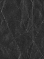 Fototapeta premium Gritty folded black paper texture overlay with distressed creases, grunge analog scan surface and vintage film grain, realistic worn background for photo editing, posters and creative design