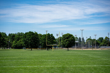Fototapeta premium Empty American football field with yellow goalposts.