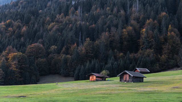 Timber cabins in autumn forest landscape offering retreat at Garmisch-Partenkirchen in Germany
