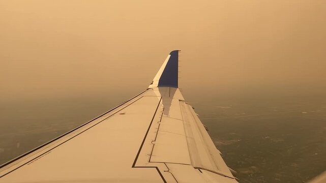 Toronto, Ontario, Canada - July 15, 2026 - Aircraft wing enveloped in thick wildfire smoke haze on approach to YYZ Toronto Pearson during a period of severe air quality deterioration from wildfires