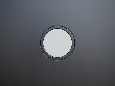 Minimalist abstract circular light fixture on dark gray background.