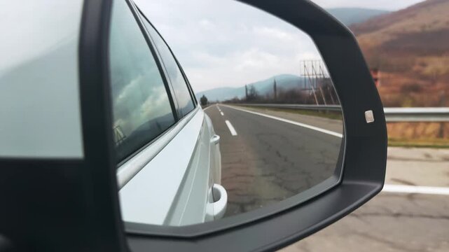 Dynamic Car Mirror Perspective on Open Highway Journey