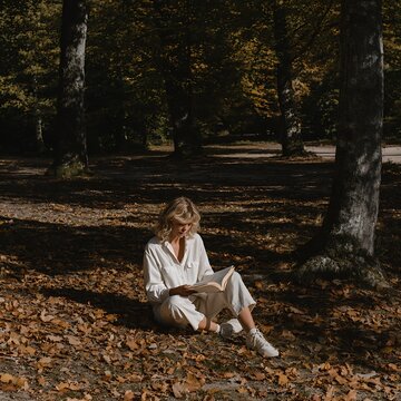 Young Woman Reading Book in Autumn Forest Lifestyle