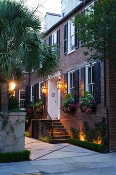 Historic Charleston brick townhouse entrance at twilight