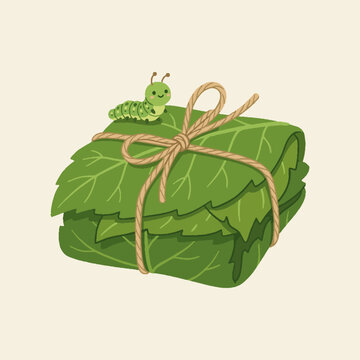 Cute cartoon caterpillar sitting on a stack of green leaves tied with a rustic twine string.