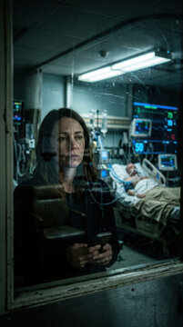 Worried Woman Watches Loved One In Hospital Intensive Care