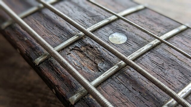 Worn Vintage Acoustic Guitar Wood Fretboard and Steel Strings Macro