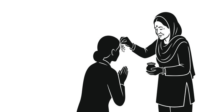 An elderly woman applying a tilak to a younger woman in a traditional gesture of blessing.