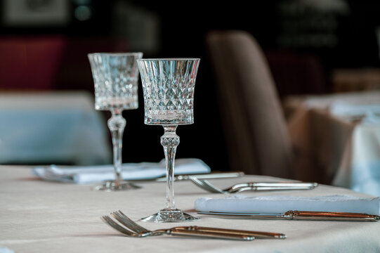 Wine glasses on a table set for dinner.