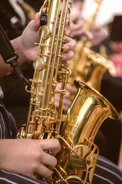 Close-up of a musician playing a saxophone during a music lesson- vertical