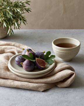 Fresh figs herbal infusion and folded linen in Mediterranean still life highlighting affordable longevity and quiet luxury wellness