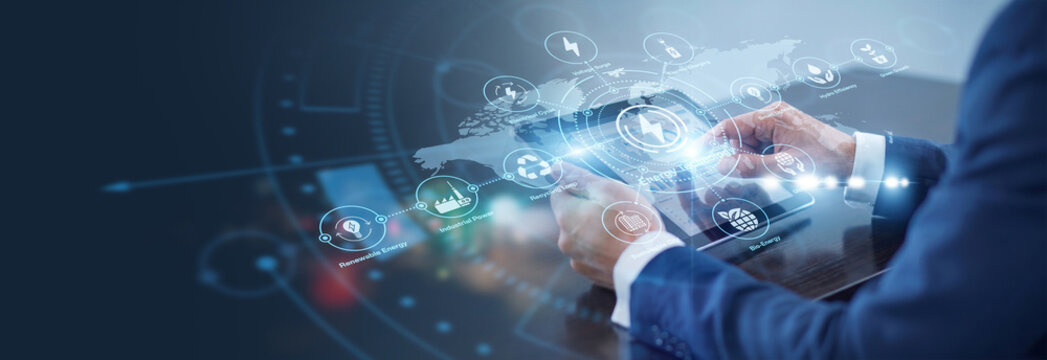 Engineer using tablet monitoring smart Energy Technology systems throughout the modern world. Sustainable infrastructure management optimizes power grid distribution and green resource usage.