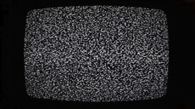 Old television screen showing analog static noise interference signal glitch black white flicker