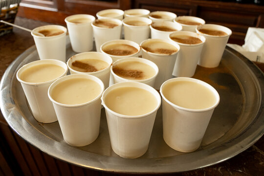 Traditional Turkish salep boza drink with cinnamon in paper cups