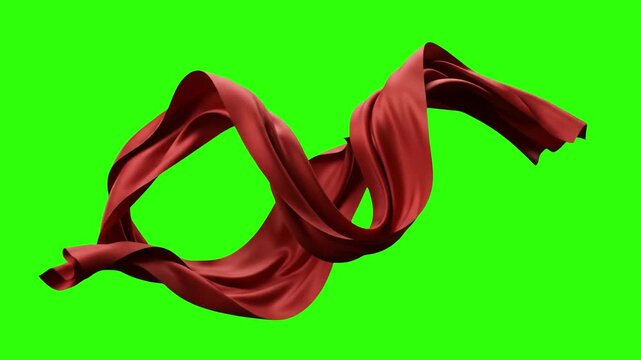 A luxurious red silk or satin ribbon floats and waves smoothly in a continuous loop. This elegant fabric motion graphic is isolated on a chroma key green screen.
