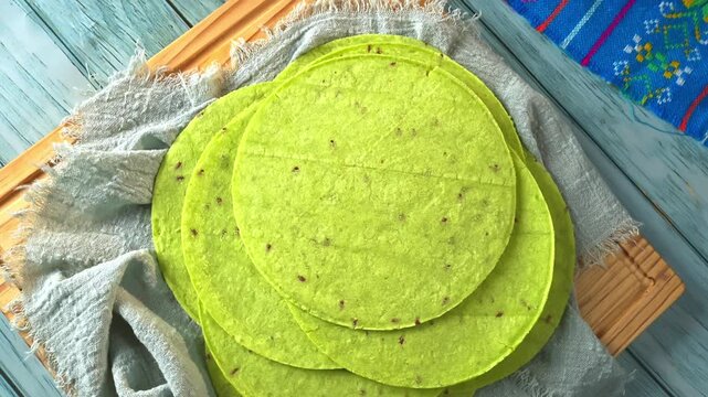 Close-up of traditional green corn tortillas with nopal flavor, perfect for healthy Mexican cuisine, tacos, and clean eating. Rustic kitchen setup